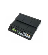 Close-up view of the Yamaha DTX-MULTI 12 electronic percussion pad, featuring 12 velocity-sensitive trigger pads in a compact split-level black design with illuminated controls, USB ports, and audio outputs for drummers and producers.